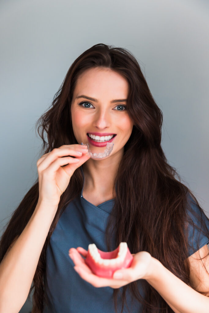 Inivisalign braces or aligner. Dentist advice how invisible orthodontics make beautiful teeth in dental clinic.