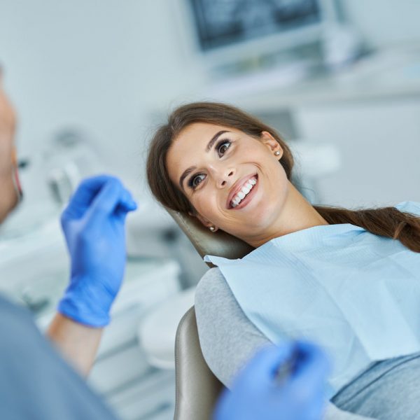 Male dentist and woman in dental clinic